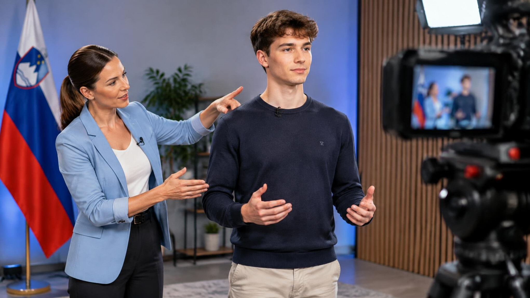 Instructor guiding a student on posture in front of a camera
